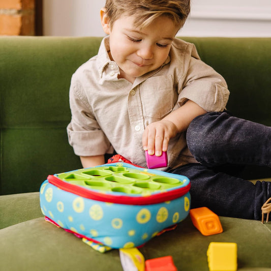 9 textured shape blocks sized for little hands to drop through matching holes